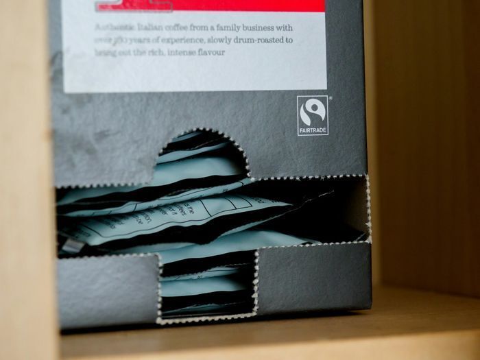 Black structural carton featuring a perforated tear-away dispenser window for frustration-free packaging fulfillment