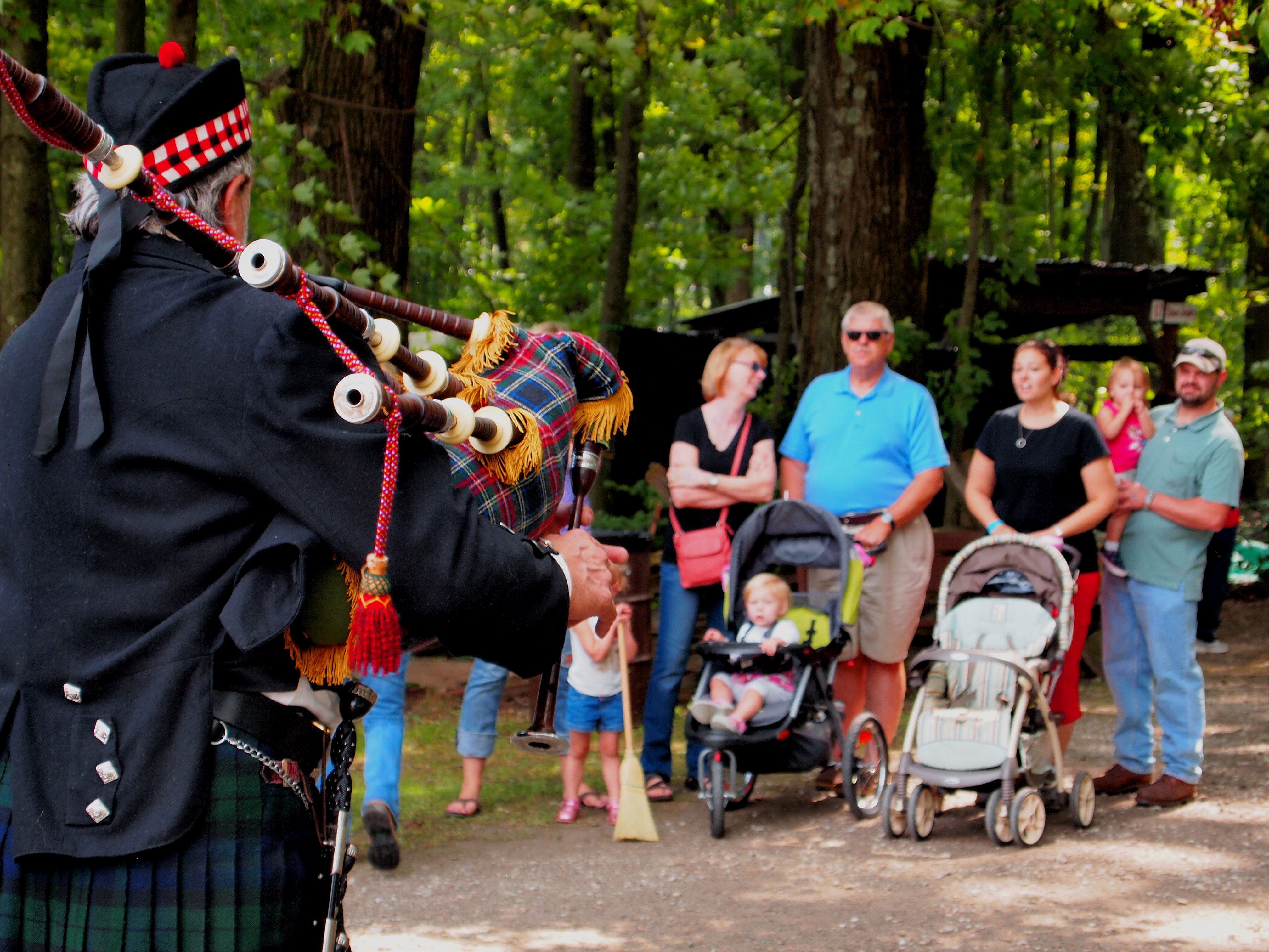 Crowd outdoors at Mountain Craft Days with tents along a gravel path.