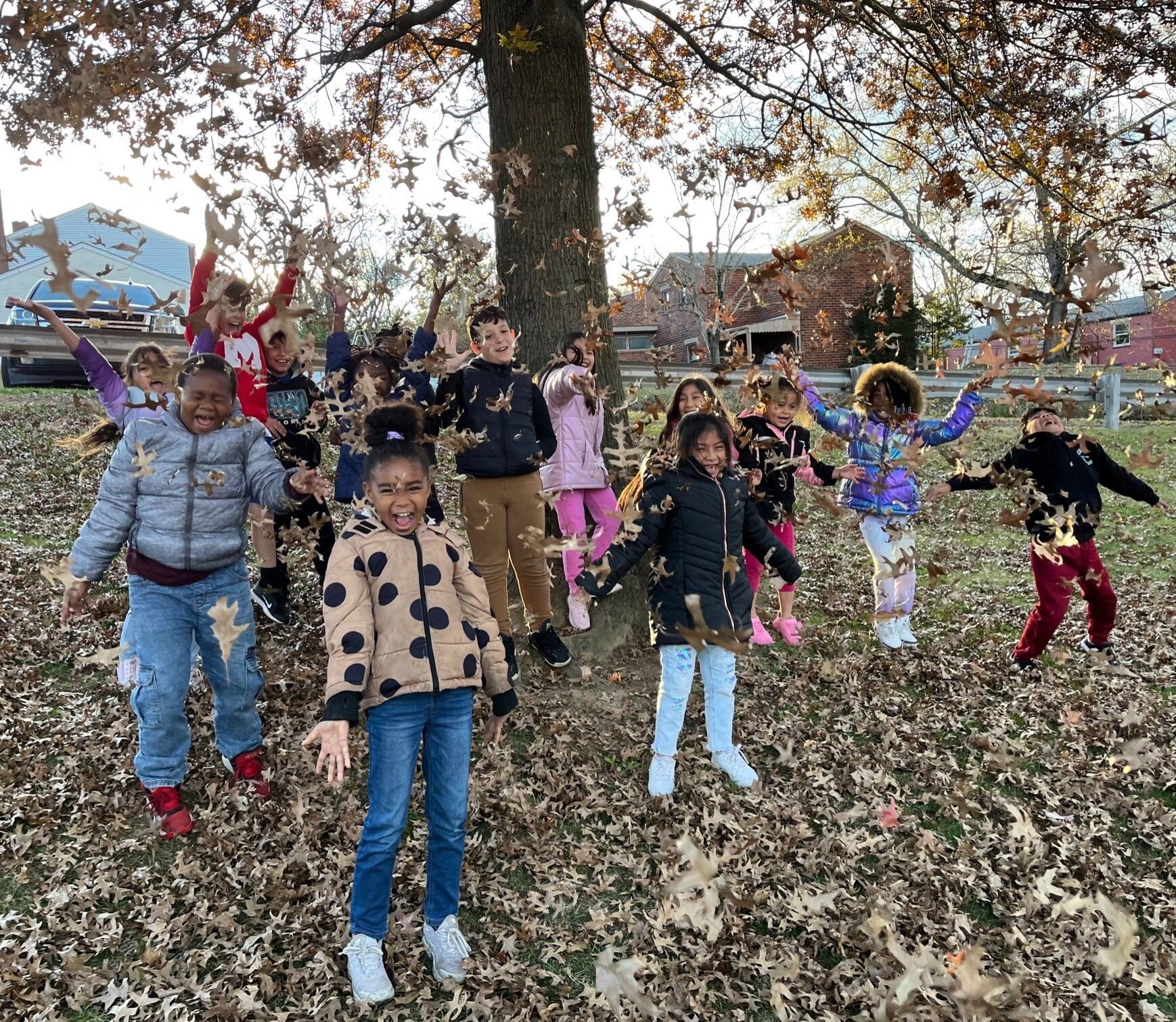 Children playing in autumn leaves.