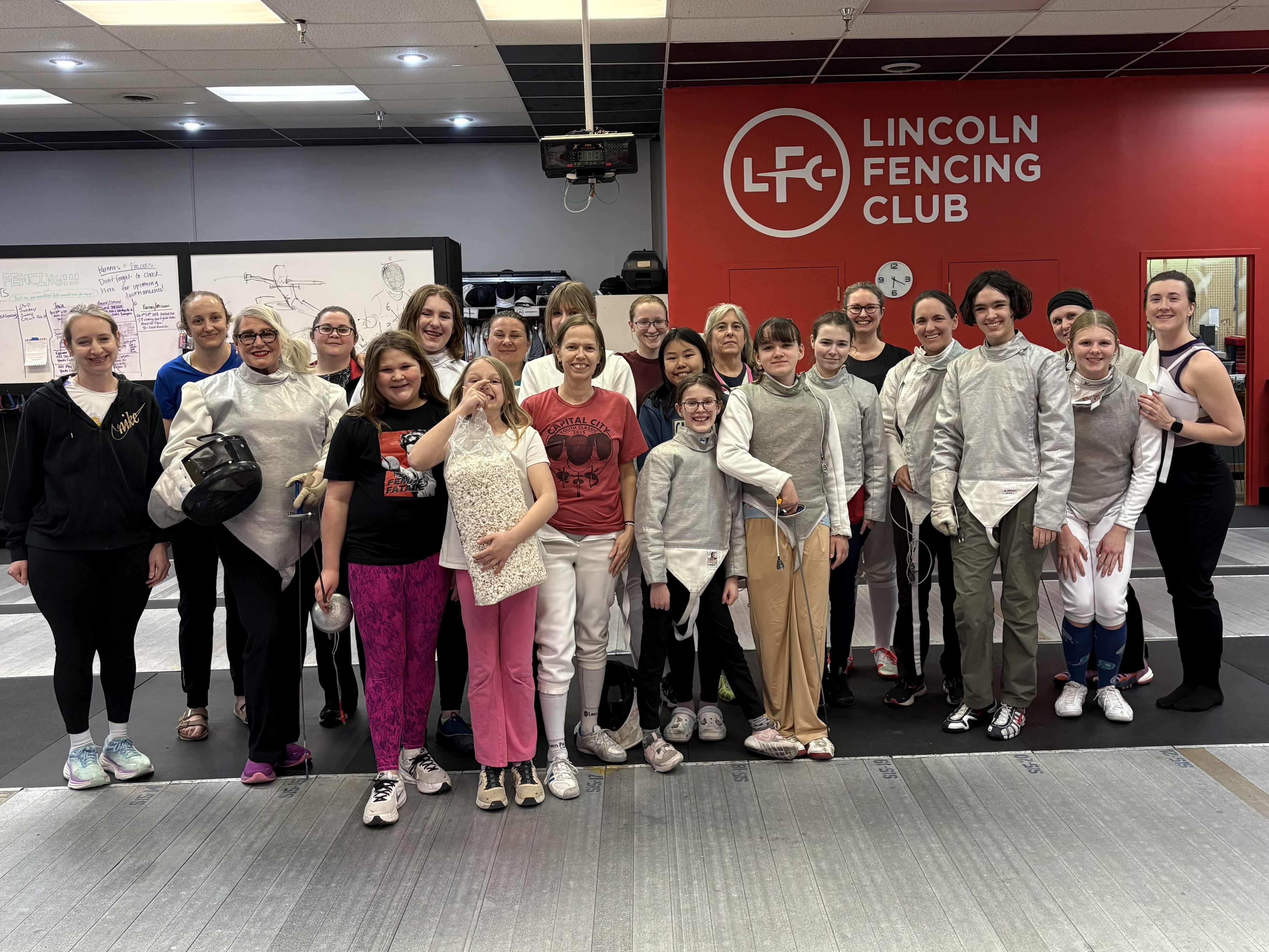 A group of female fencers pose for the camera