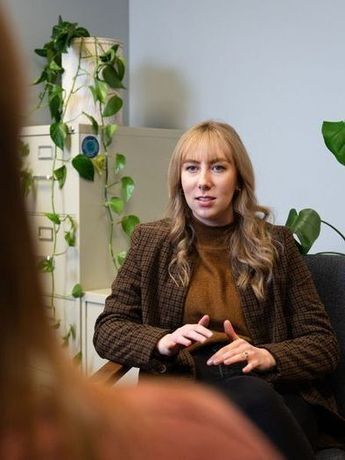 Woman, Stephanie, sitting talking with client