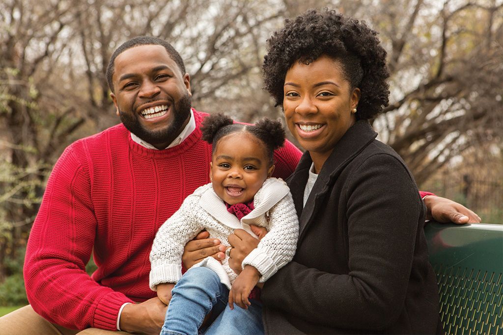 Mother, Father and child smiling.