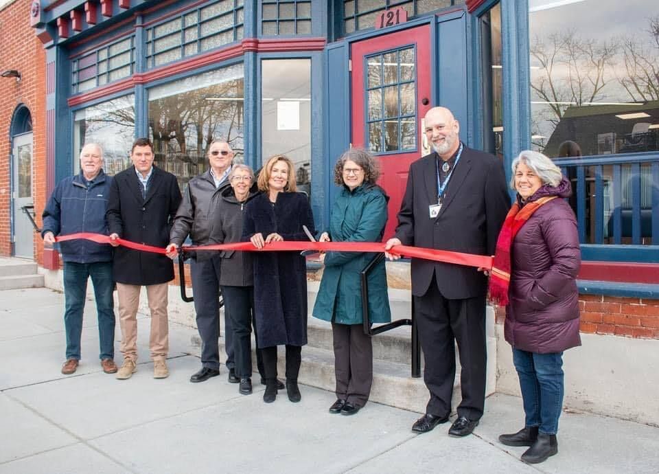 Members of the Library cut the ribbon at the Library's new location on March 28, 2022.