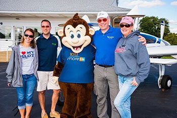 Group of volunteers with a monkey mascot.