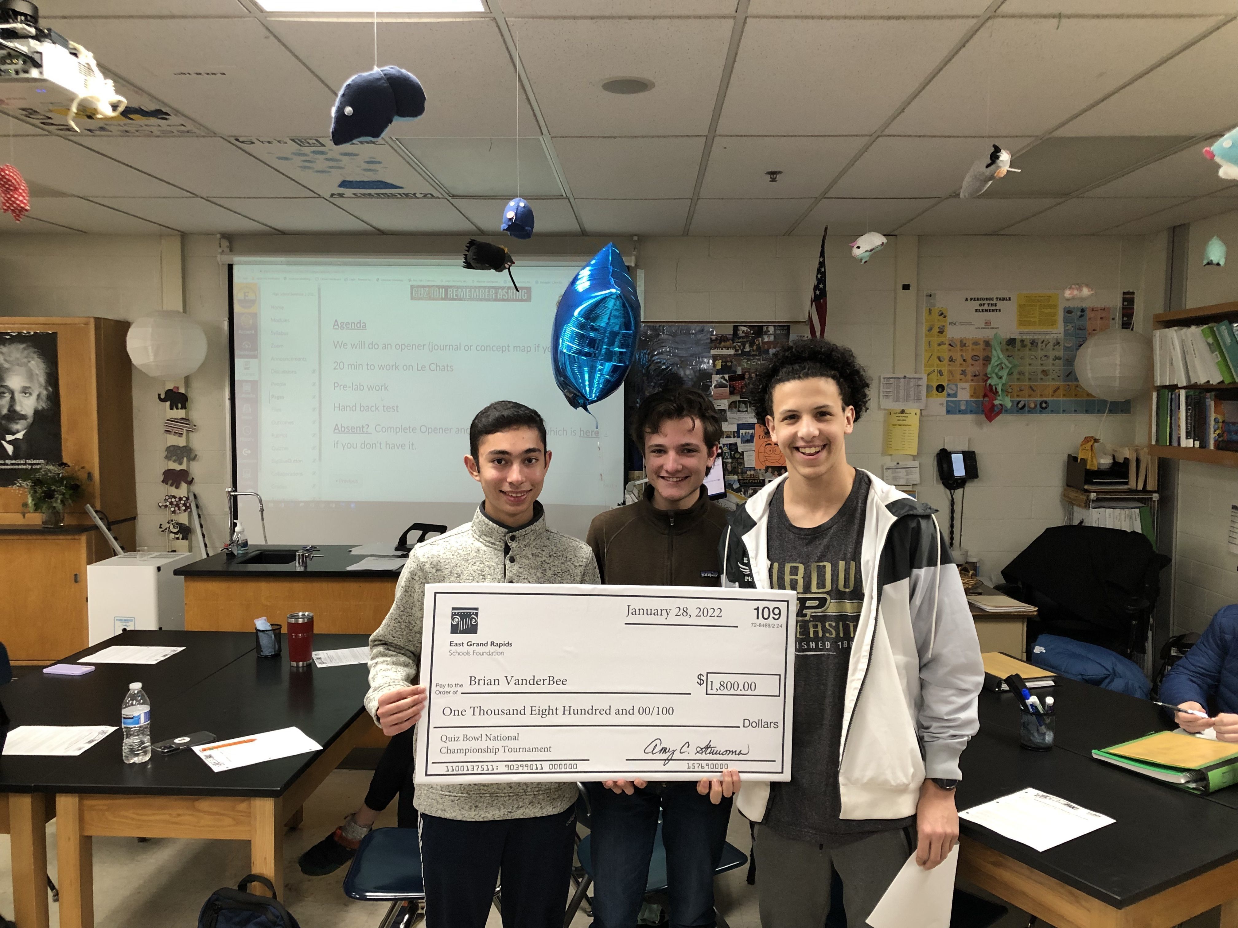 Quiz Bowl team with big check