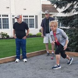Three people playing bocce