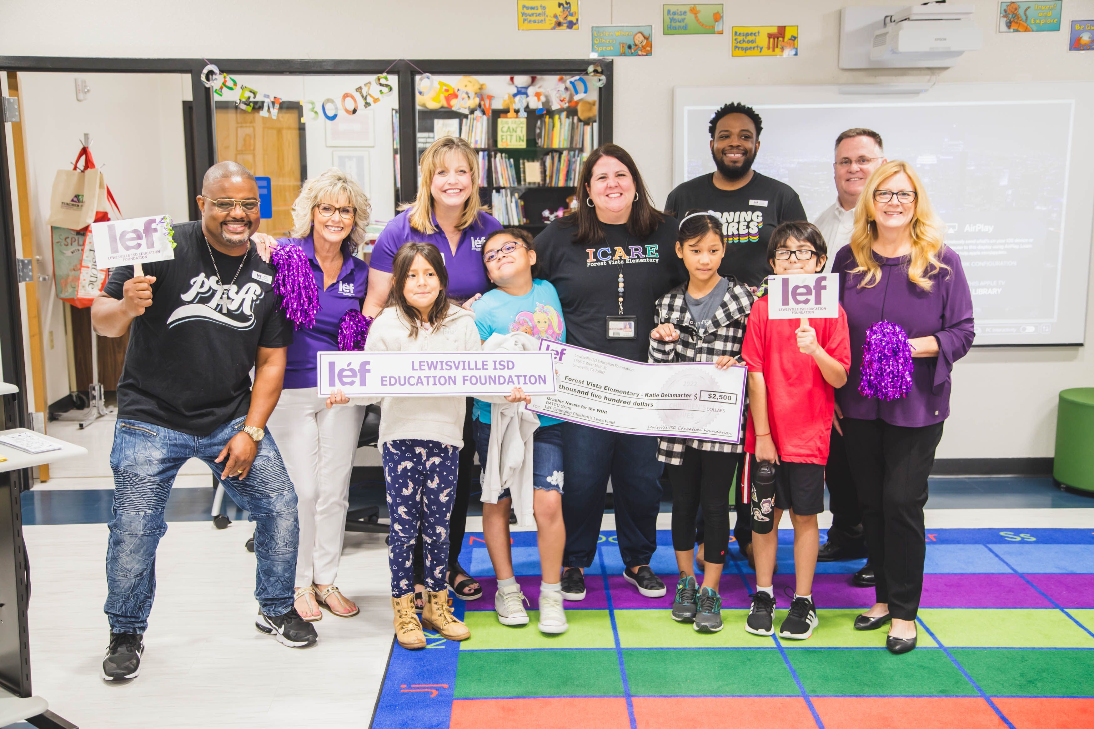 LEF volunteers surprise a LISD librarian with a 2022 teacher grant.