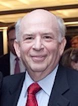 Louis Morrell, Board Chair. An image of a man who in his 60's and he is wearing a suit with a tie. He is also smiling for the picture. 