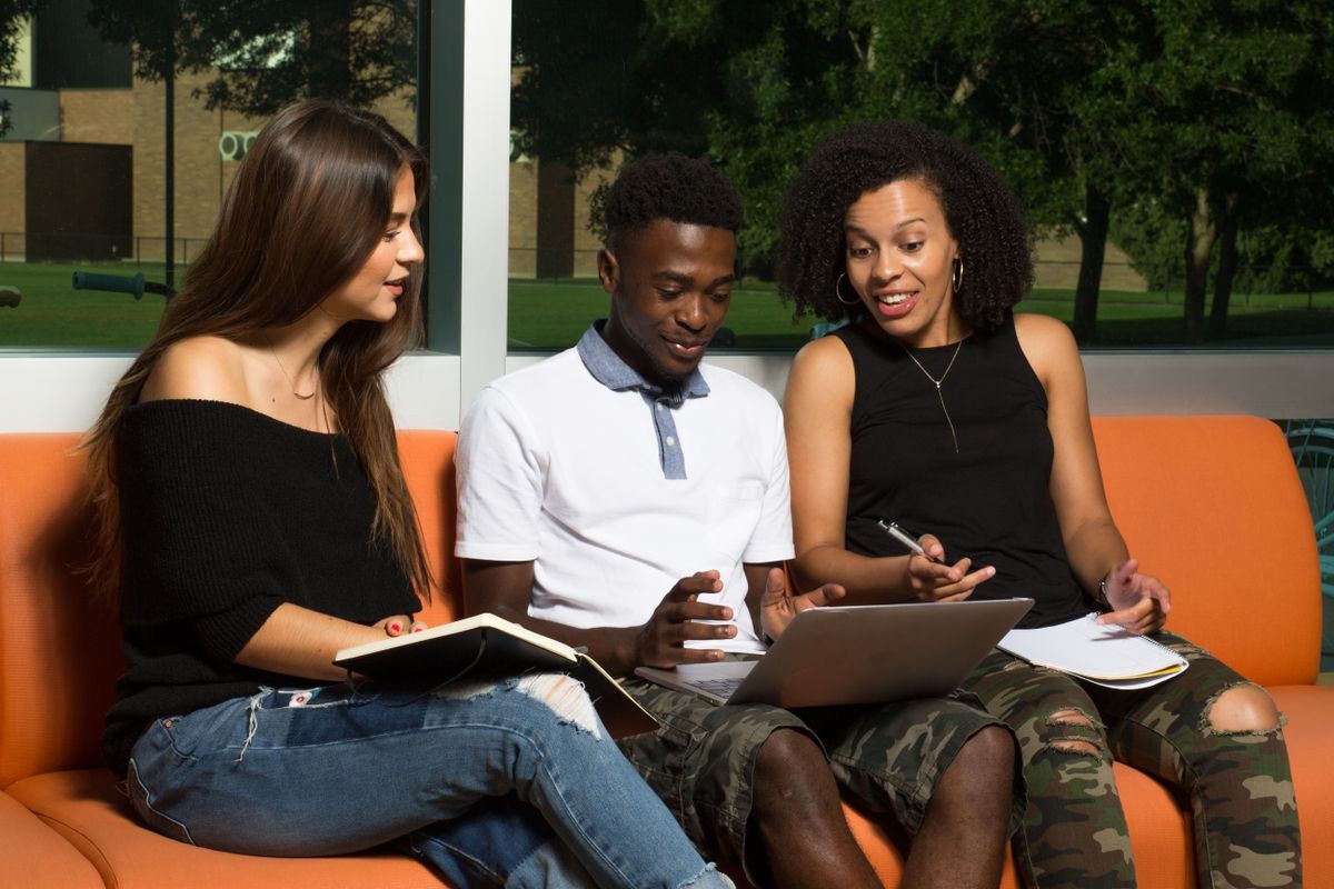BIPOC students sitting together around a laptop