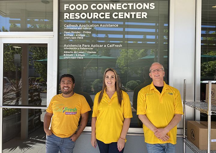 Food Connections Resource Center staff standing in front of center and smiling to welcome people
