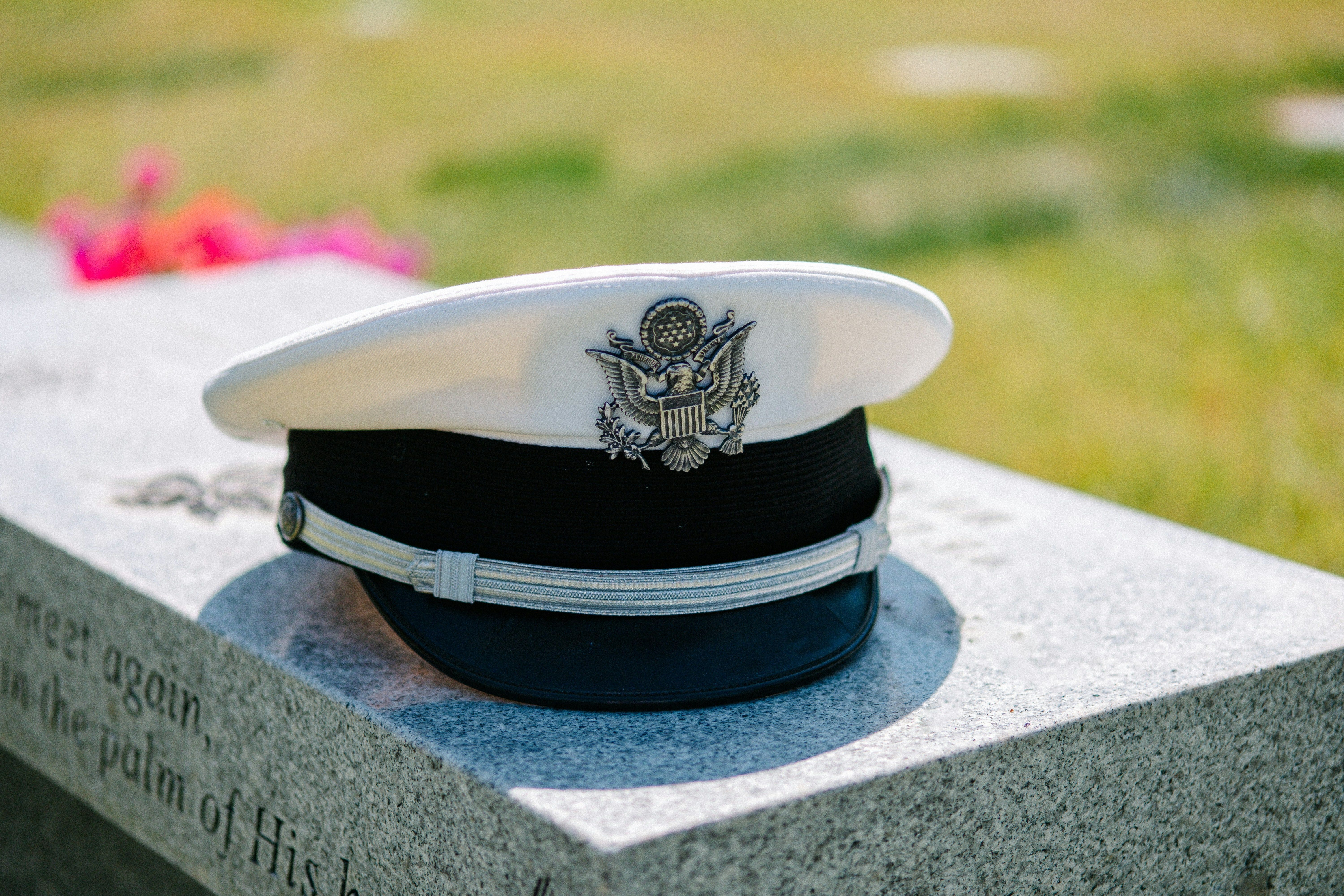 A man in military uniform sitting in a wheelchair, smiling with two children.