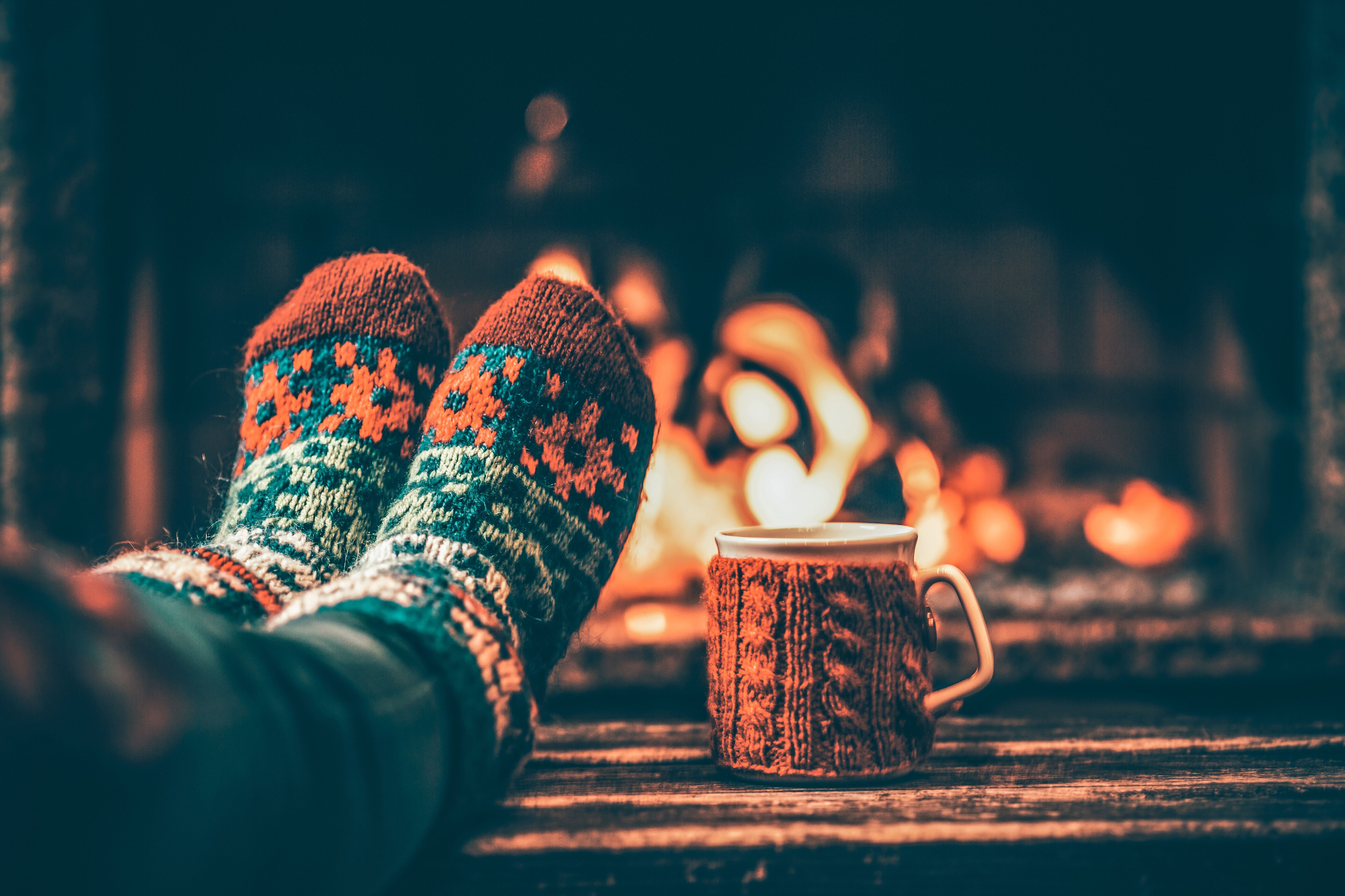 A person relaxing in front of the fire