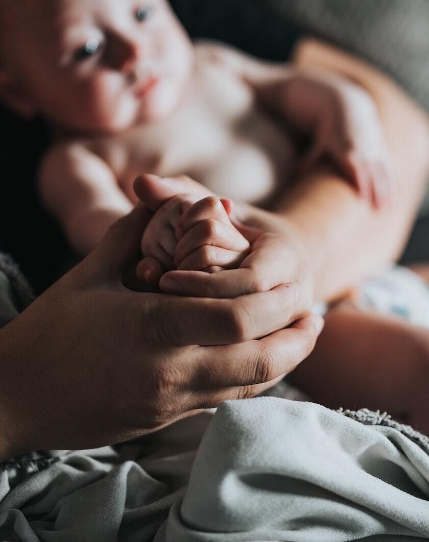 Baby's hand in Parent's hand