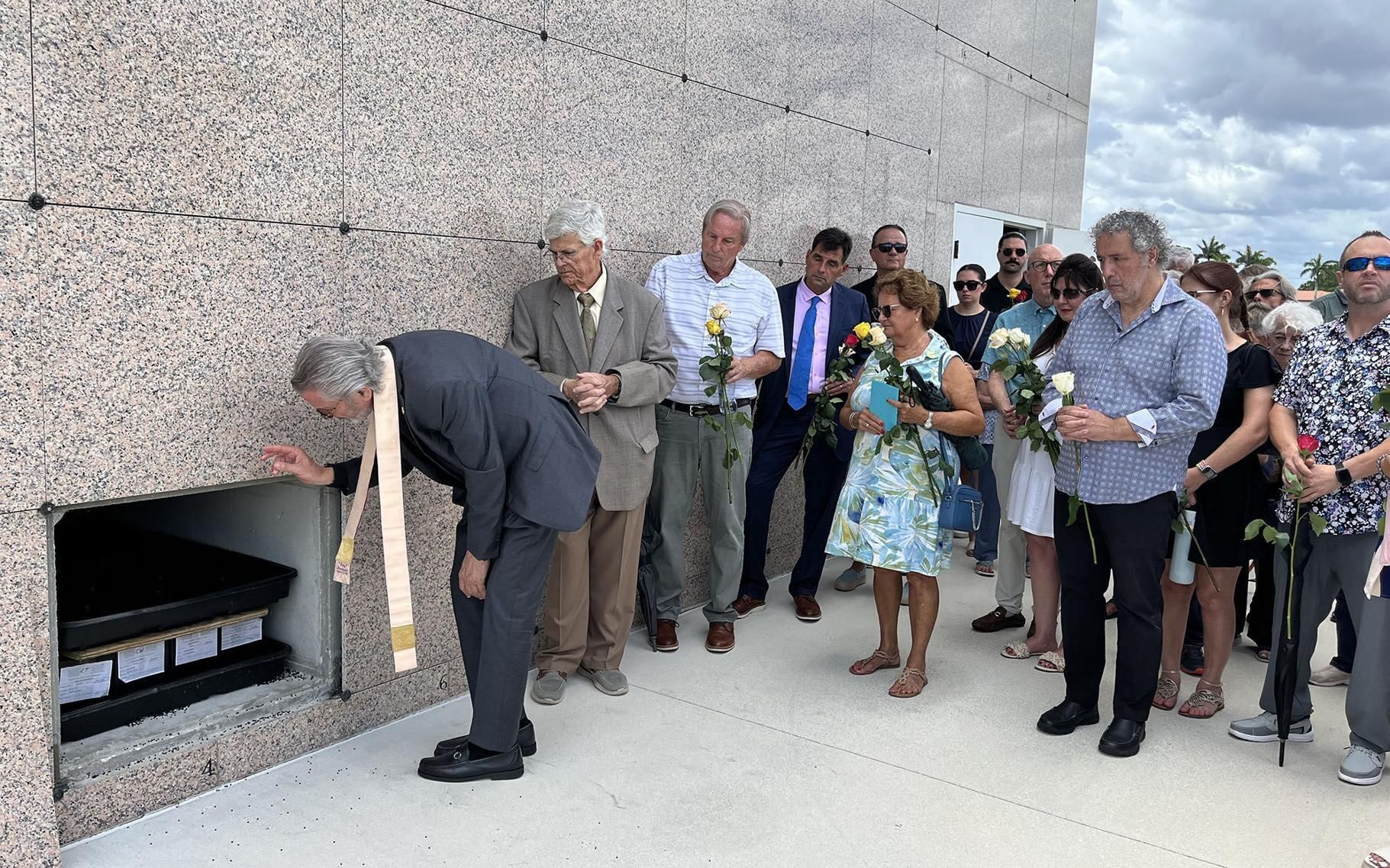 Father Gabriel Ghnoum gives a final blessing to the 100 souls whose ashes were placed in a cemetery crypt June 6, 2026.