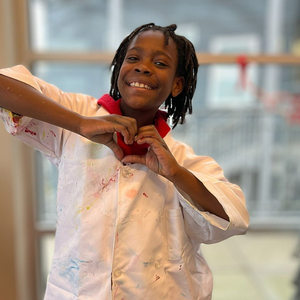 A group of young people on a basketball court with a chalk drawing that reads “THE FUTURE”.