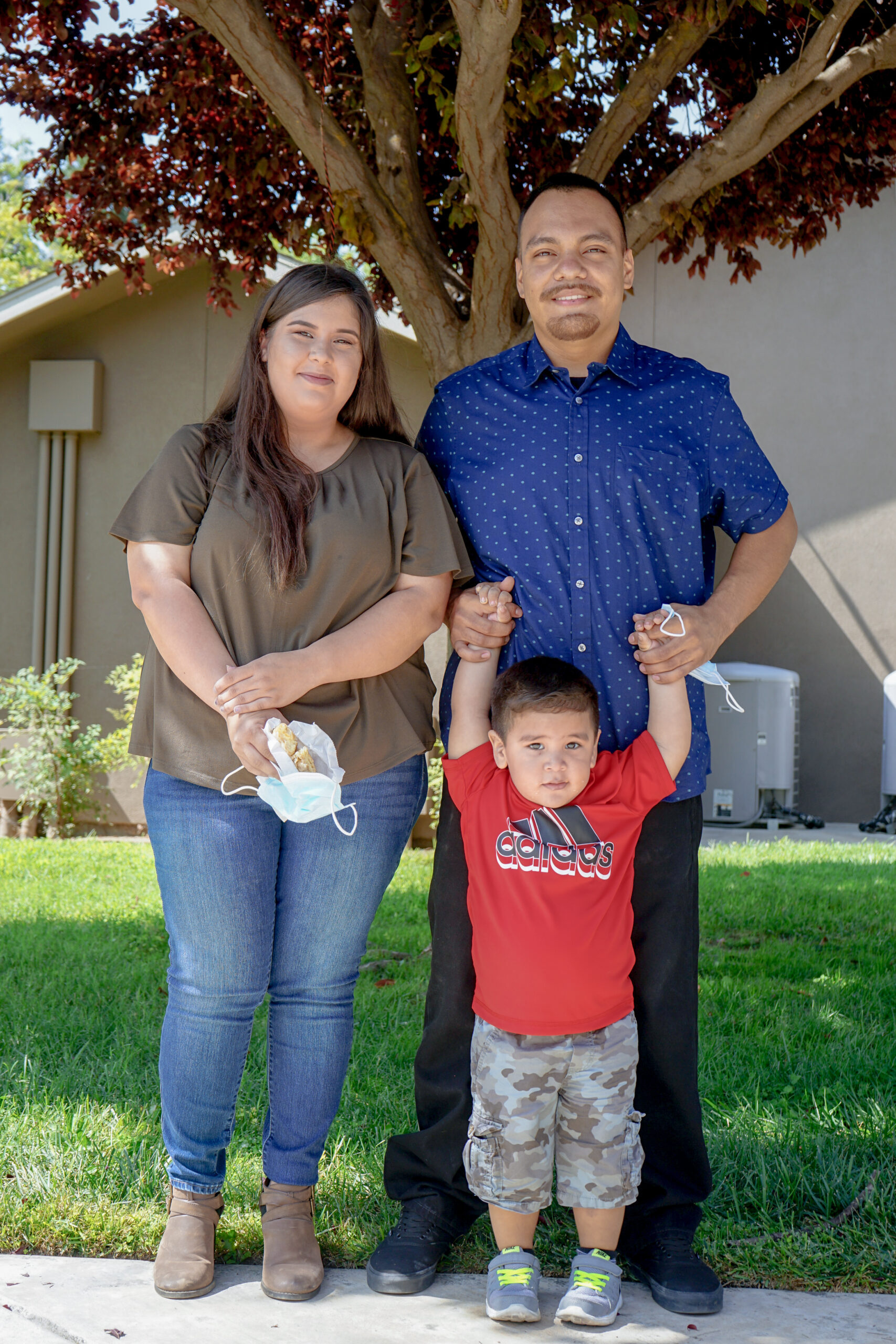 Sand Creek residents Christian Vasquez and Maria Garcia with their son