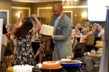 Two people celebrate selecting a dessert
