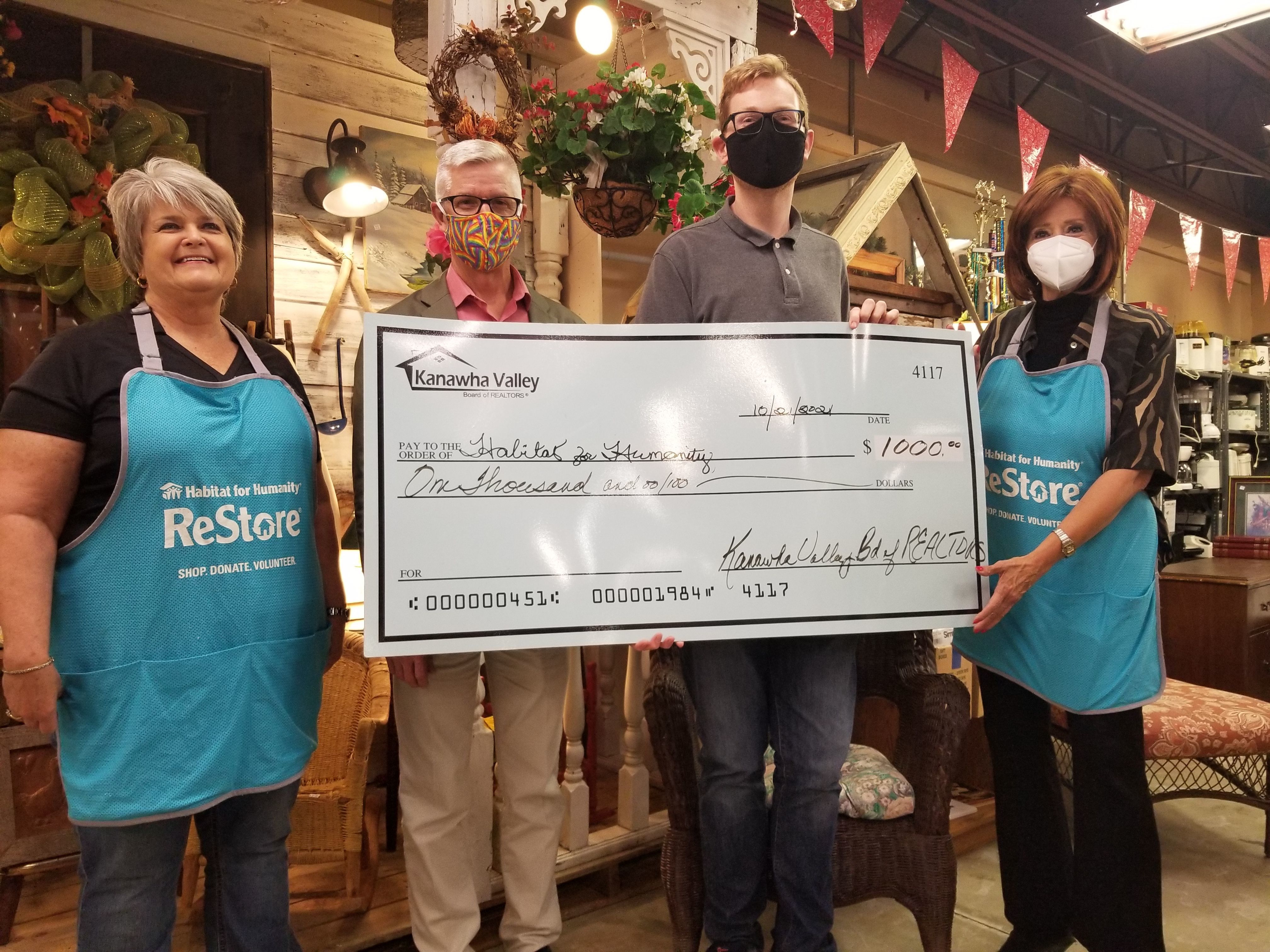Members of the Board present Habitat’s executive director, Dr. Andrew Blackwood, with a check for $1,000 that will be used to purchase new building materials.