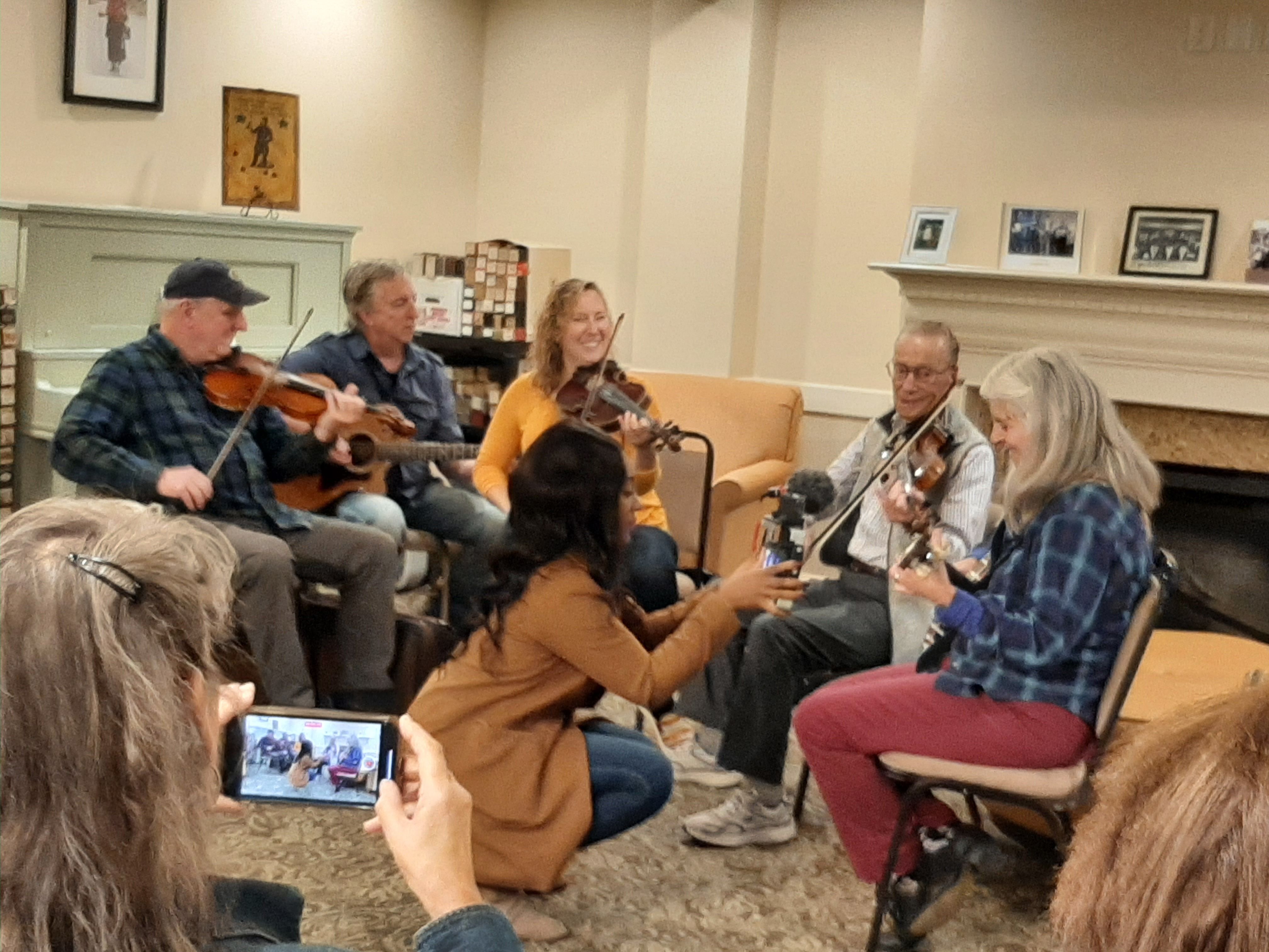 Earl and friends entertain Coburg Village residents with bluegrass jam session at a press event