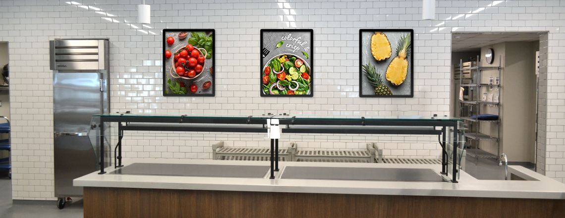 School café serving line with 2 food education posters on wall, white posters with nutrition facts