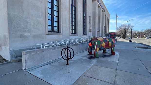 handicapped ramp at the front of the Smoky Hill Museum behind a colorful sculpture of a hippo.