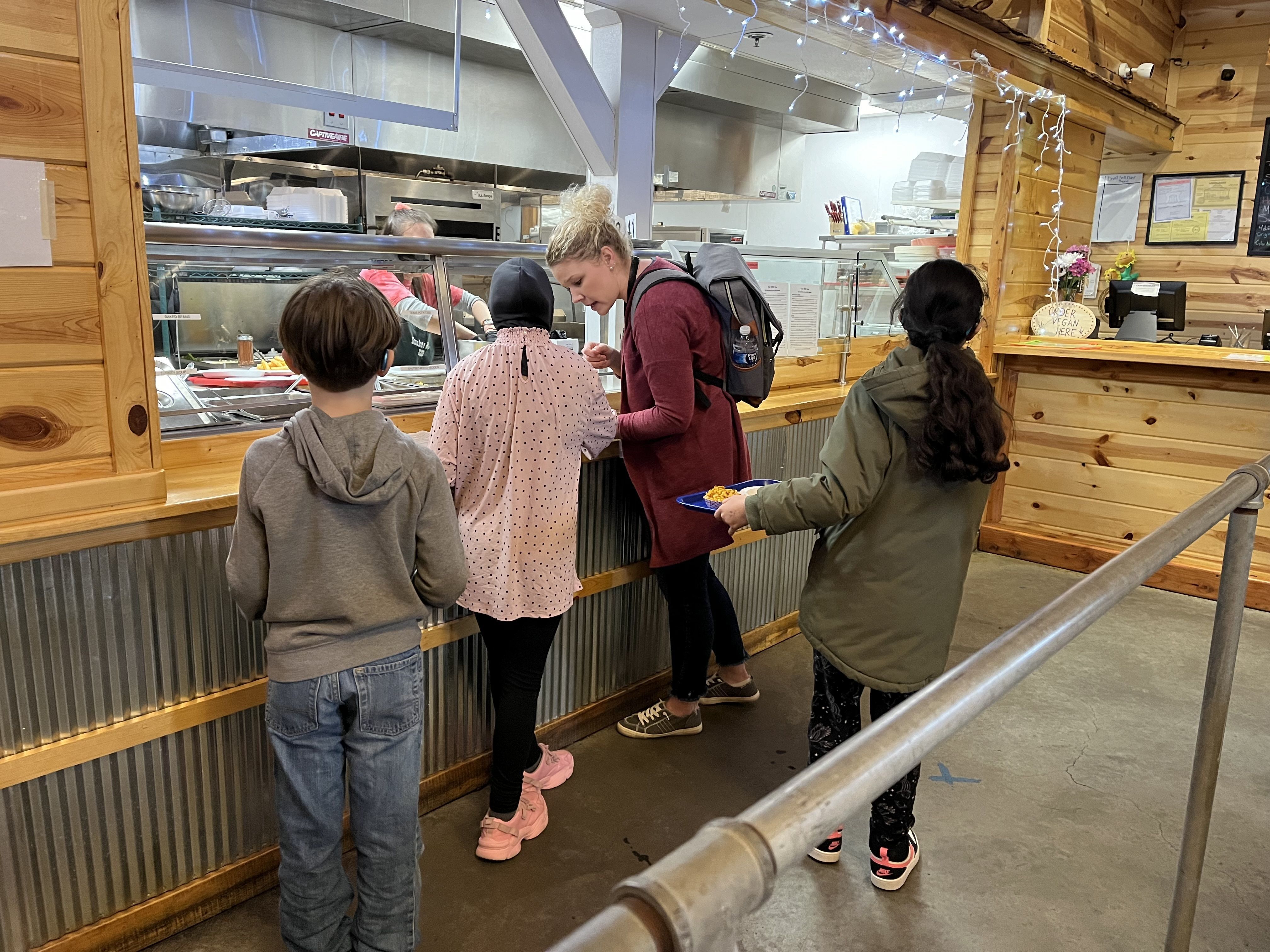 kids ordering lunch with an adult at a restaurant