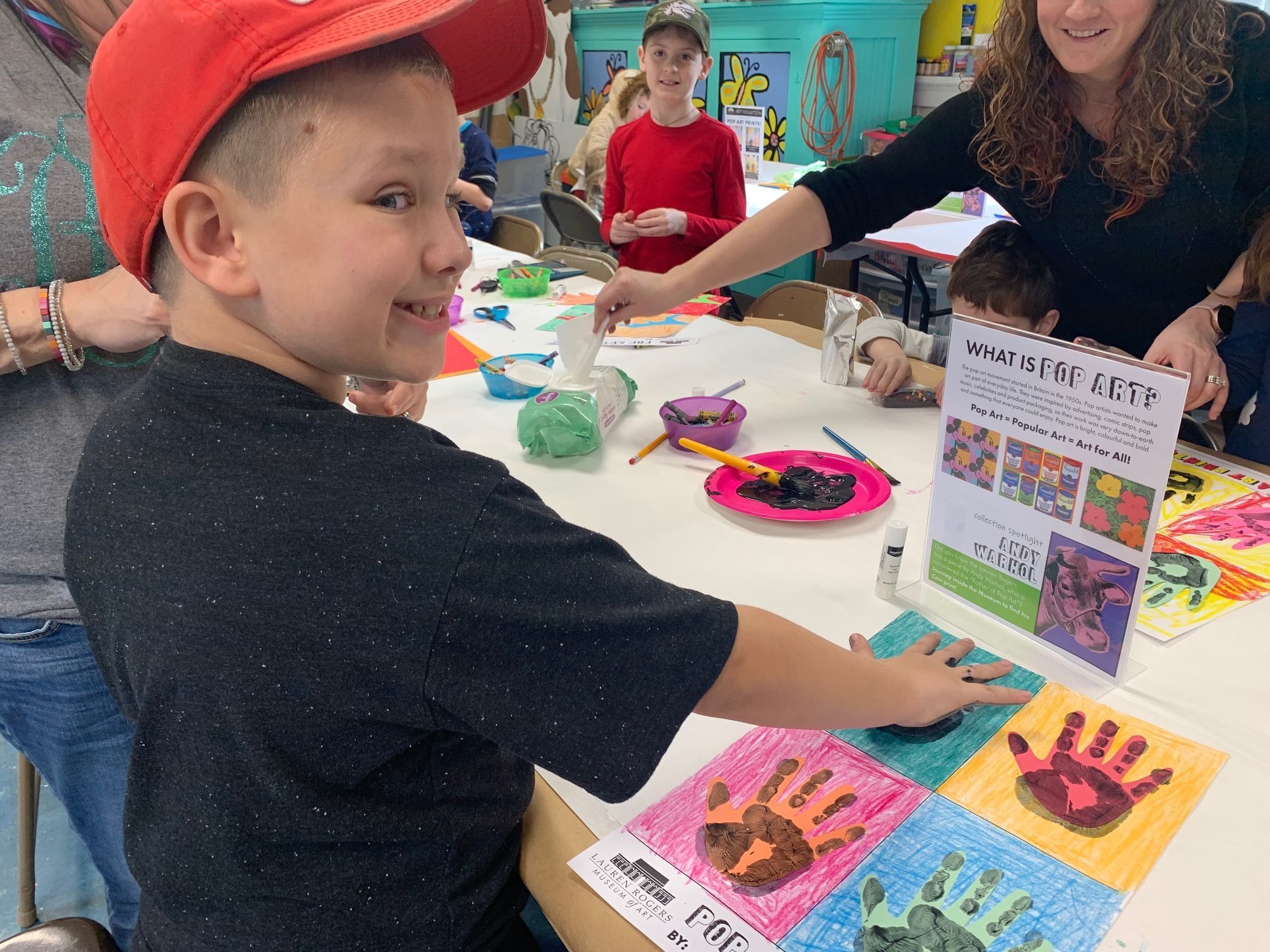 Young boy creating handprint art project