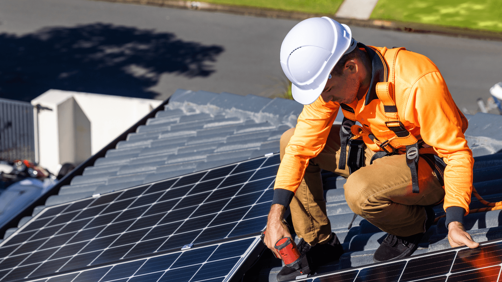 Person installing rooftop solar panel