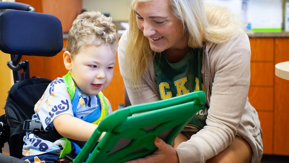 Speech-language pathologist and child in session