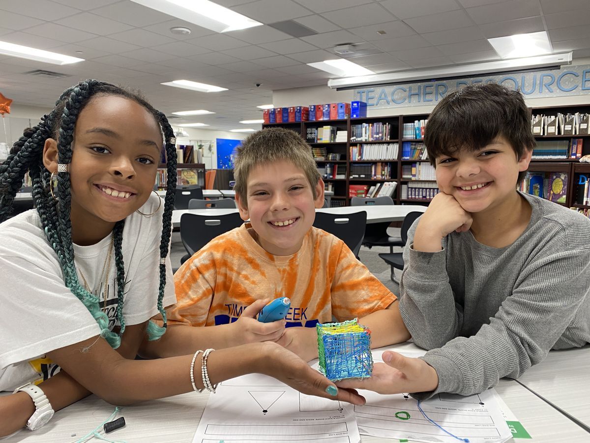 three young students using 3D pen