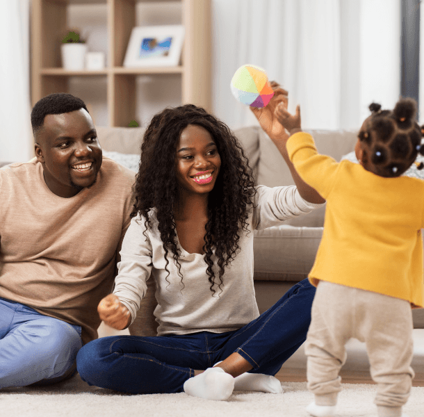 a family playing with their daughter