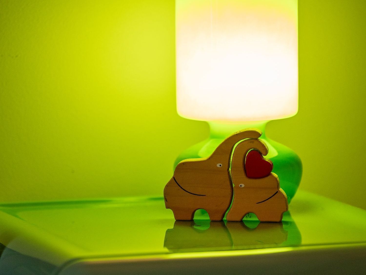 Hands holding a black paper heart.