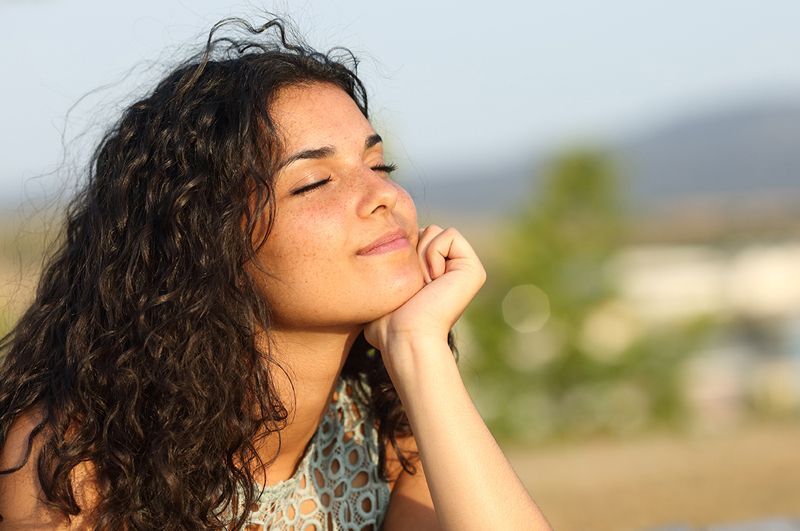woman with eyes closed and a pleasant expression on her face