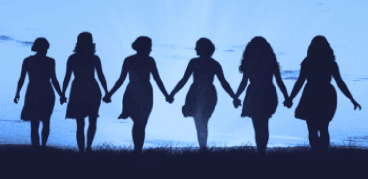 Girls outside creating heart shapes with their hands