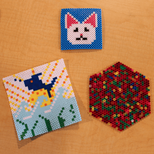 plastic fused beads that form a picture of a cat with a blue background and a fish under water