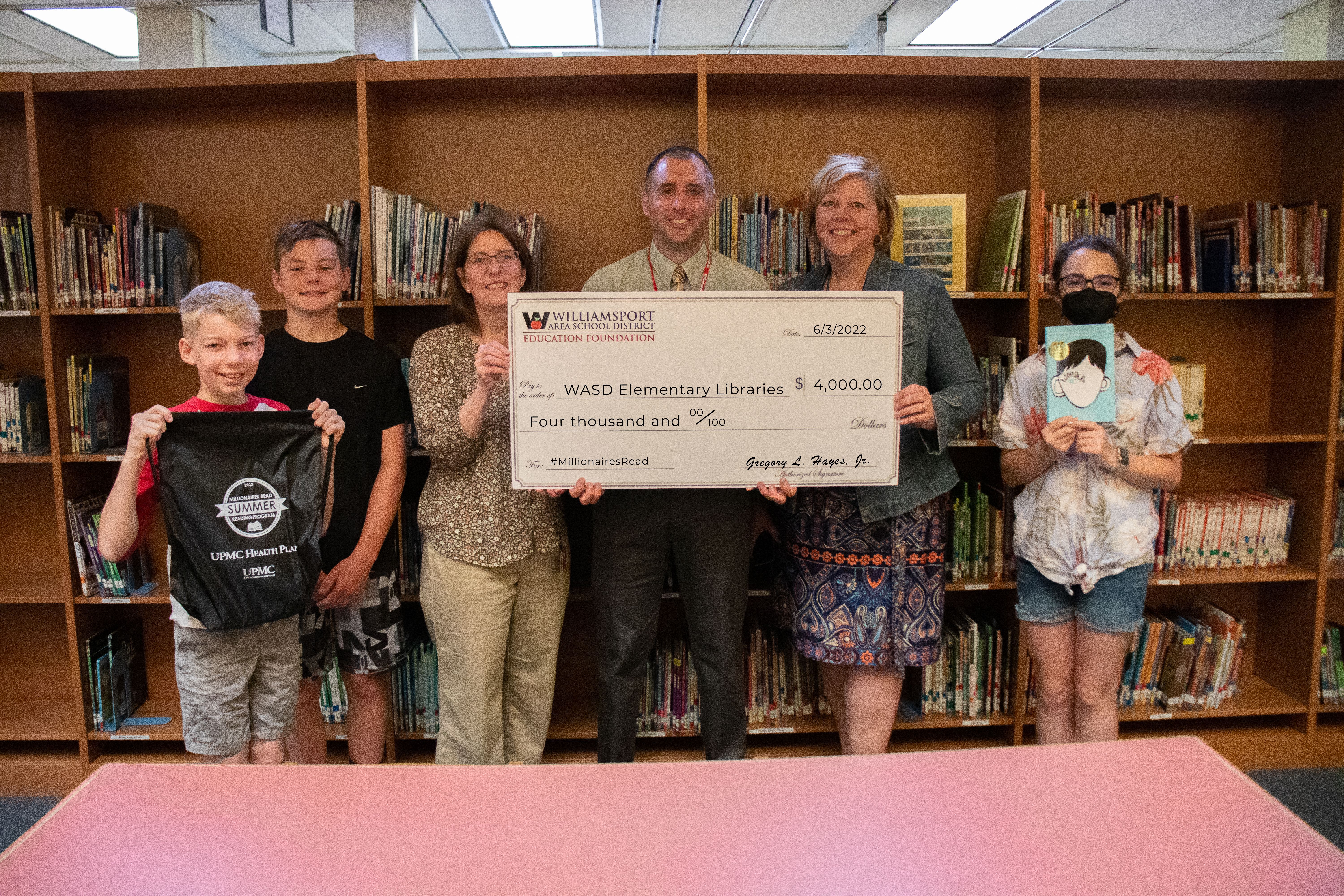 The library system is presented with a check for $4,000.