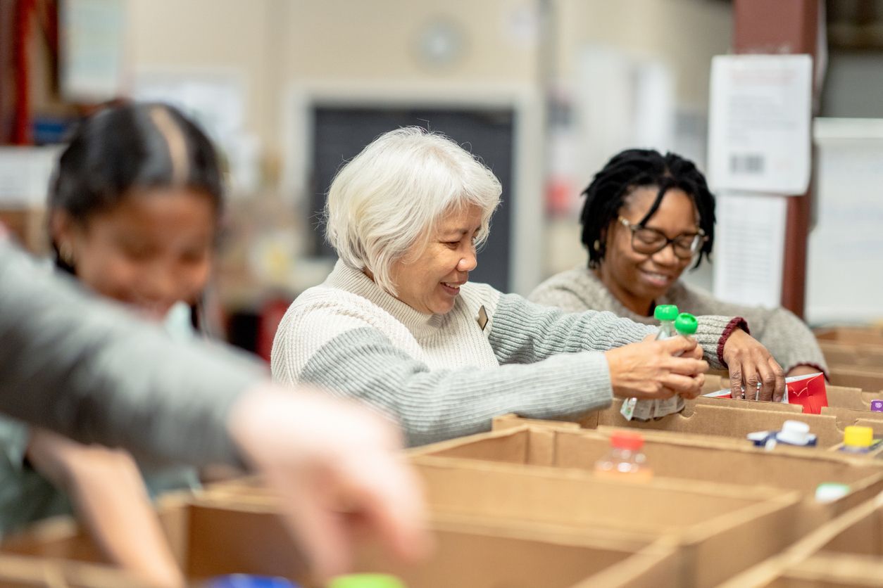 women filling up boxes with food