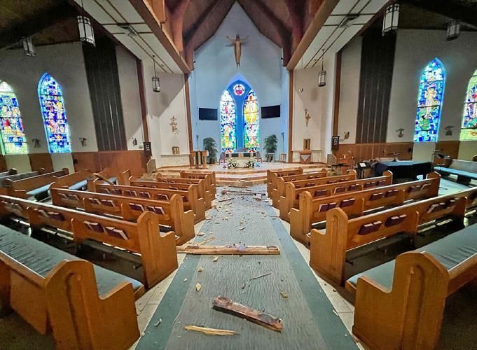 Sunlight shines through a hole in the roof of Holy Cross Church in Vero Beach as the parish recovers after a tornado