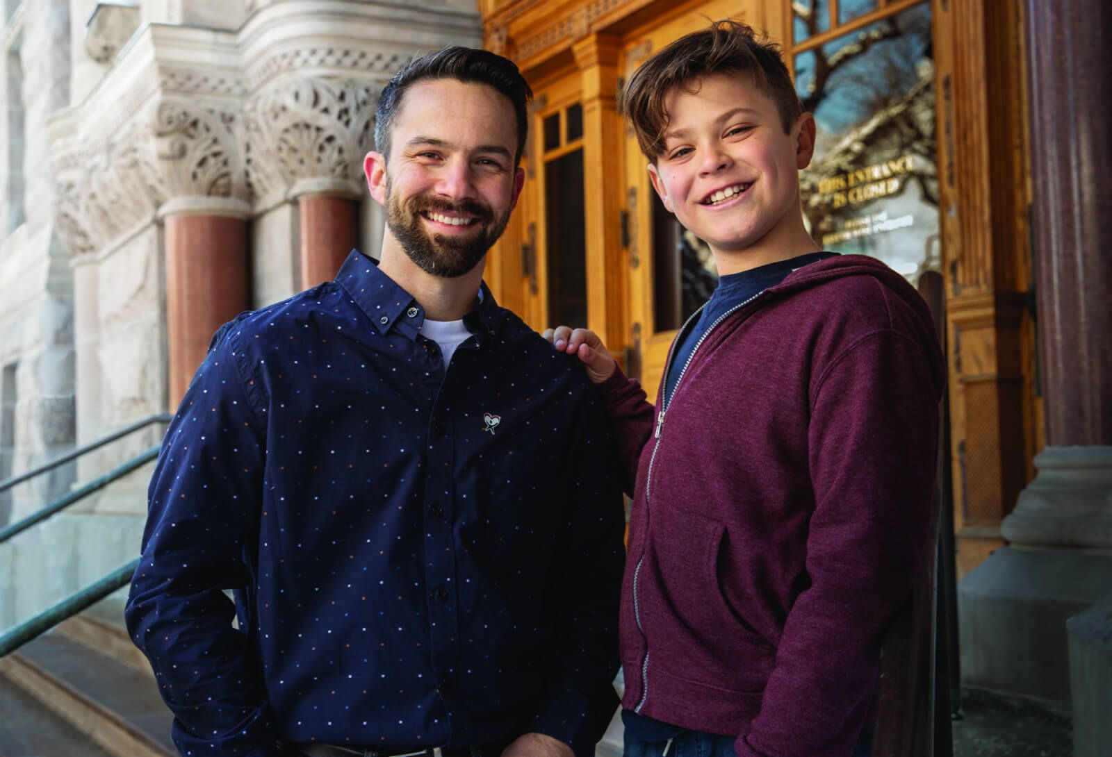 Teen boy stands with his CASA volunteer advocate