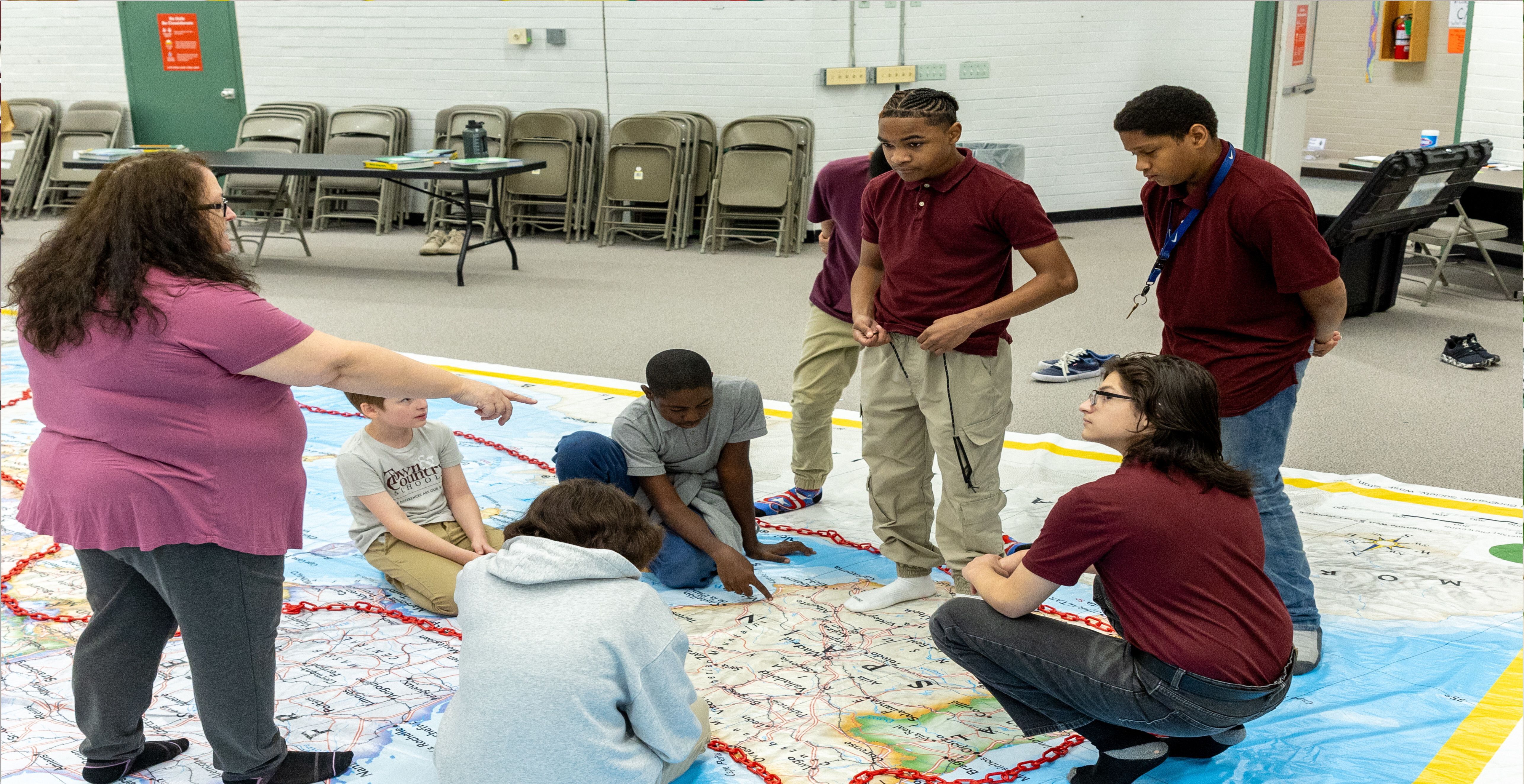 Teacher working with students on a geography lesson