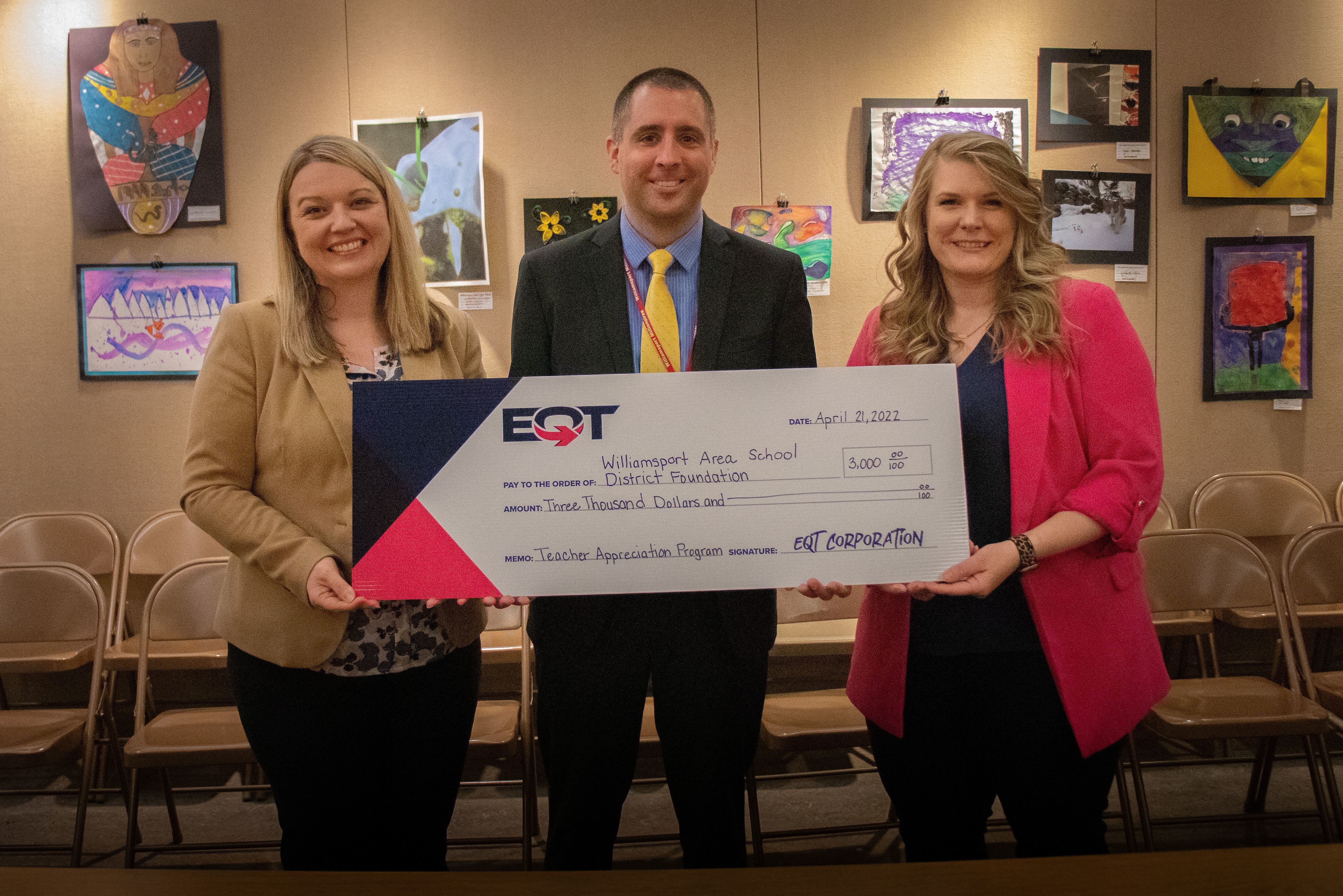EQT representative, Kelly Coppadge, stands with ED Greg Hayes and WASDEF board President Dr. Brooke Beiter with a big check. 