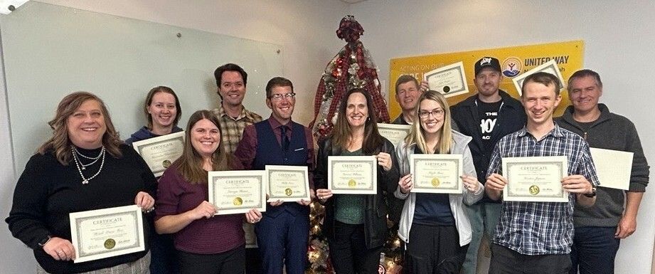 This photo shows the graduates of the 2025 Project Blueprint, board governance program, United Way Northern Utah. Each person is holding their certificate of graduation and donning a large smile.