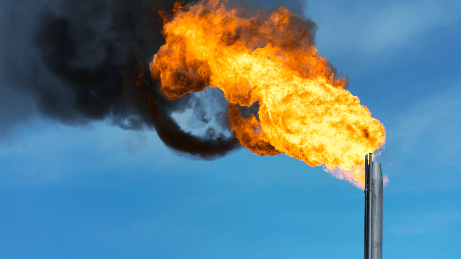 Photo of methane flaring against blue sky