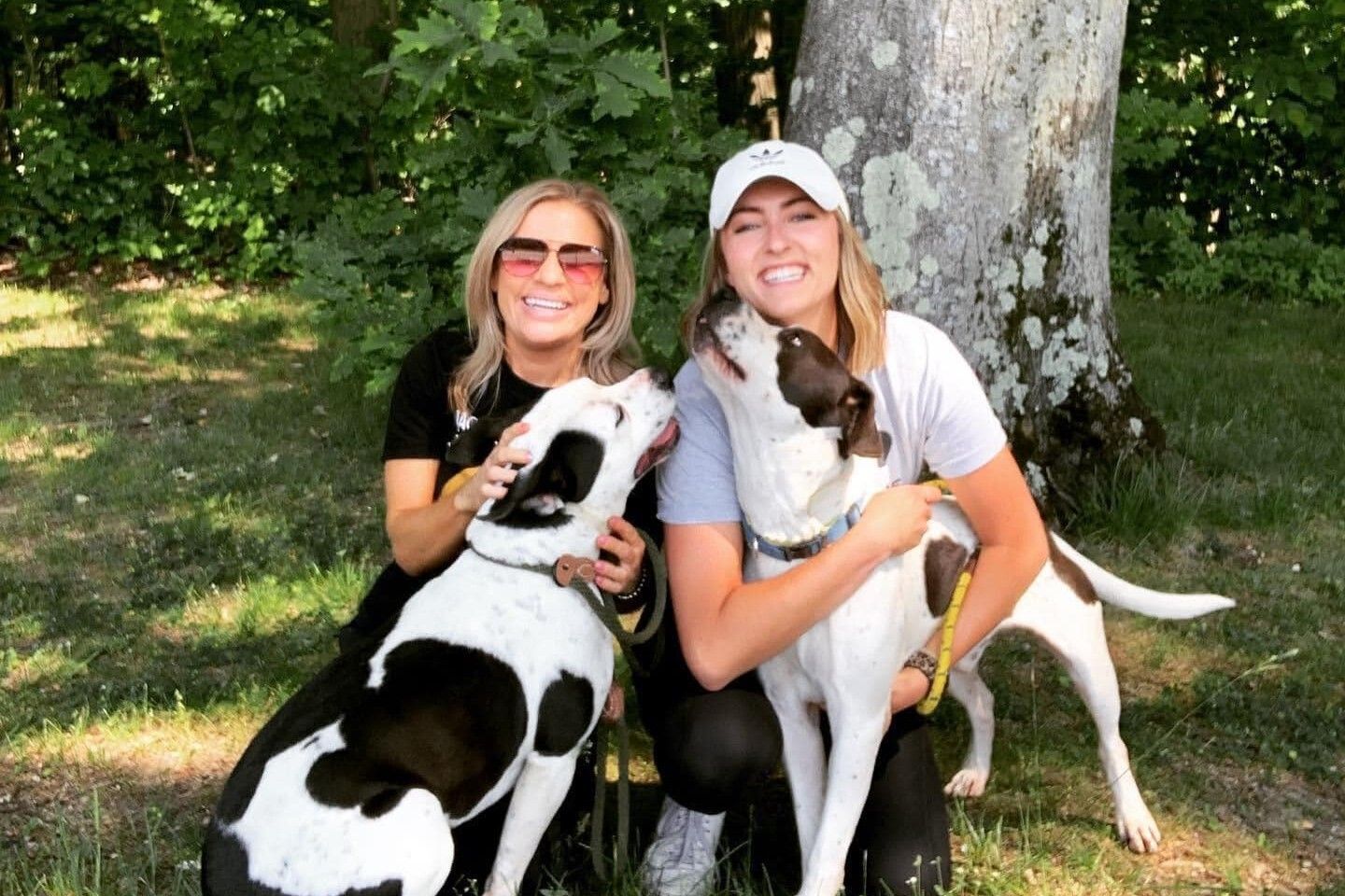 Two Women Smiling With Two Dogs