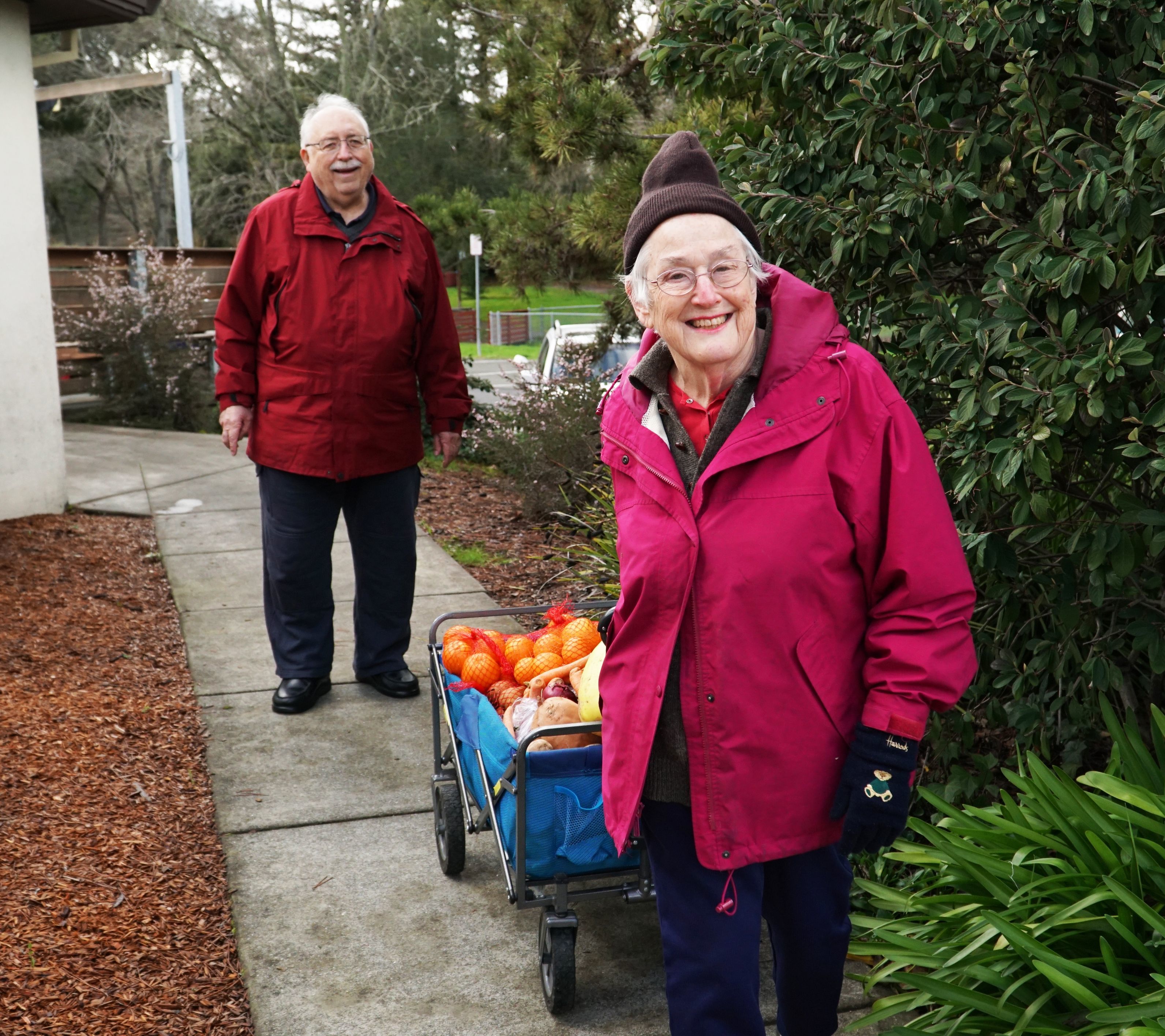 Senior couple smiling with food from the food bank