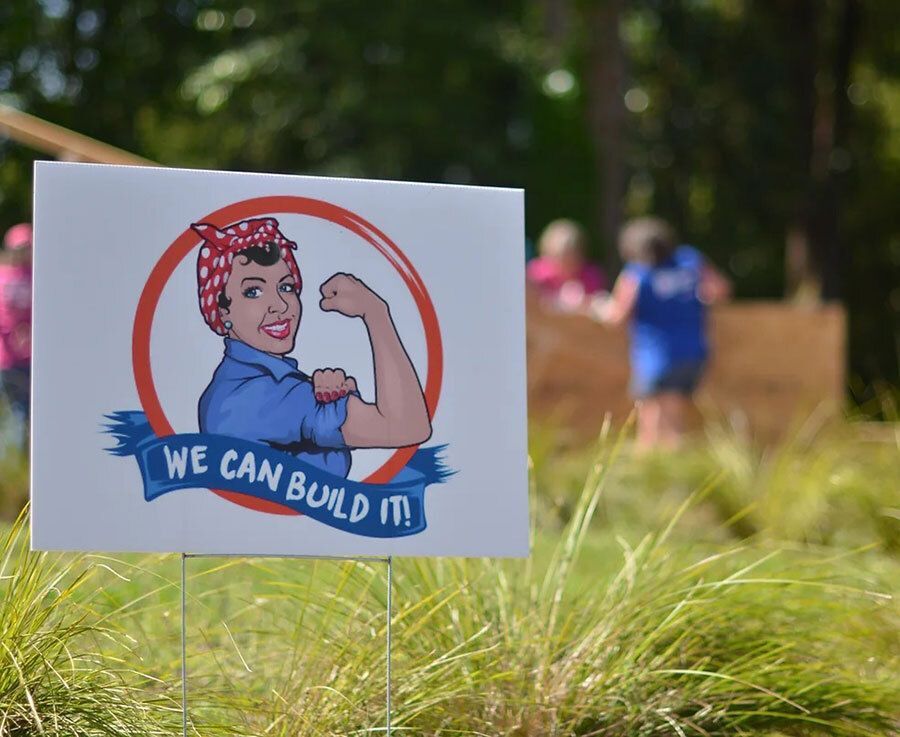 Rosie the Riveter on a Women Build sign.