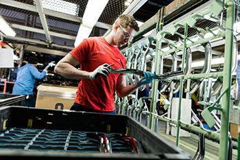 Man inspecting metal parts.