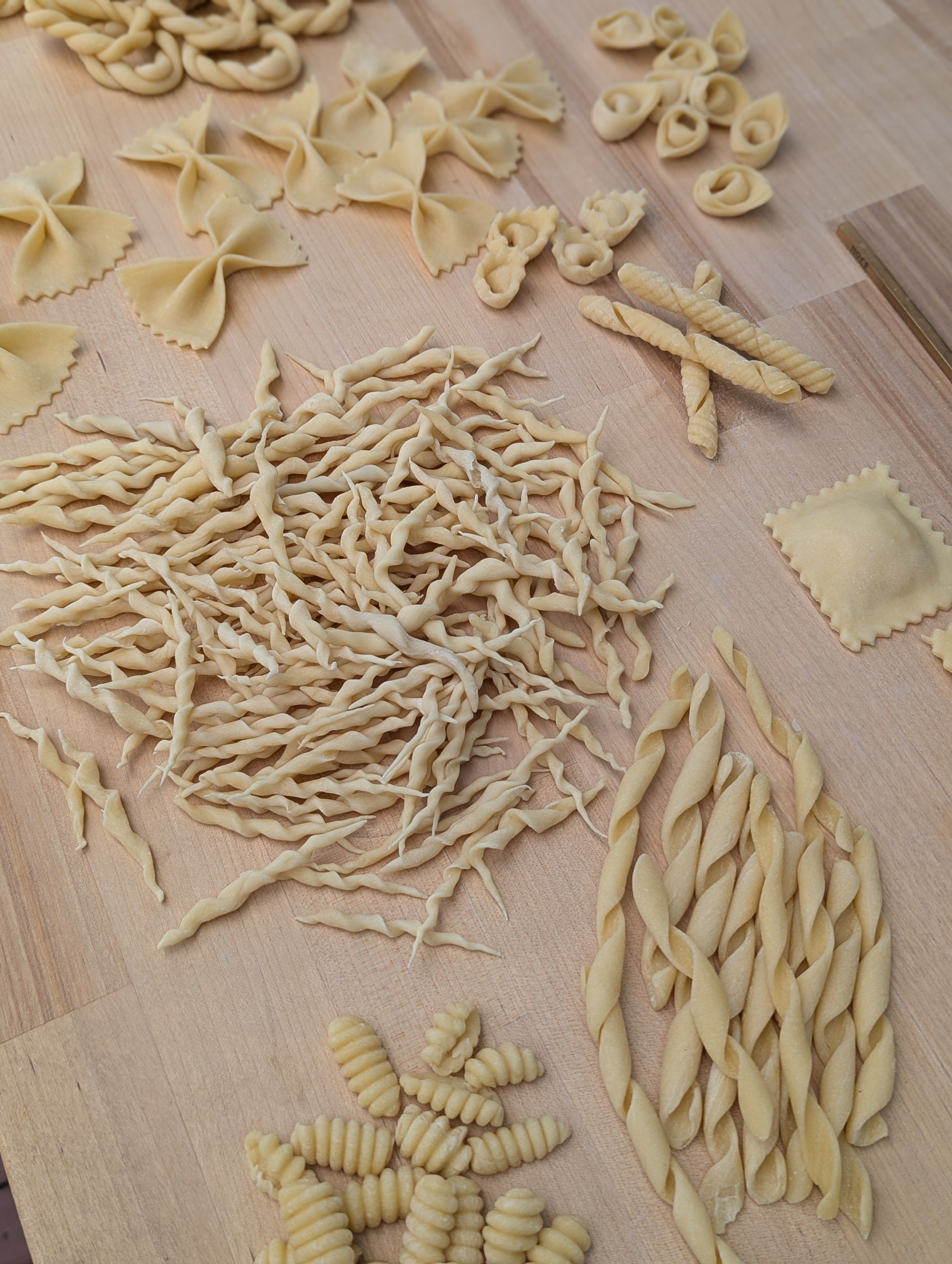 Variety of pasta in different shapes on a kitchen work surface