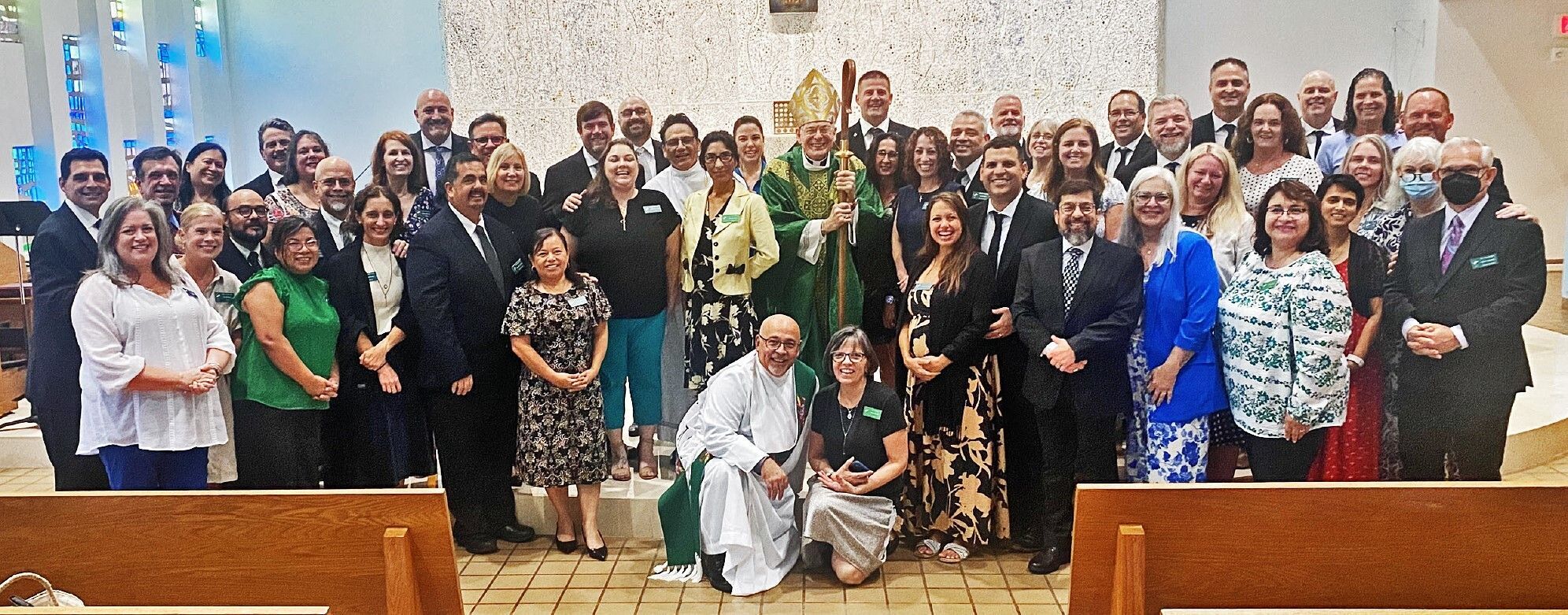 Twenty-five men in the Diocese of Palm Beach's Permanent Diaconate Formation Program pose with their wives and Bishop Gerald M. Barbarito at their July retreat.
