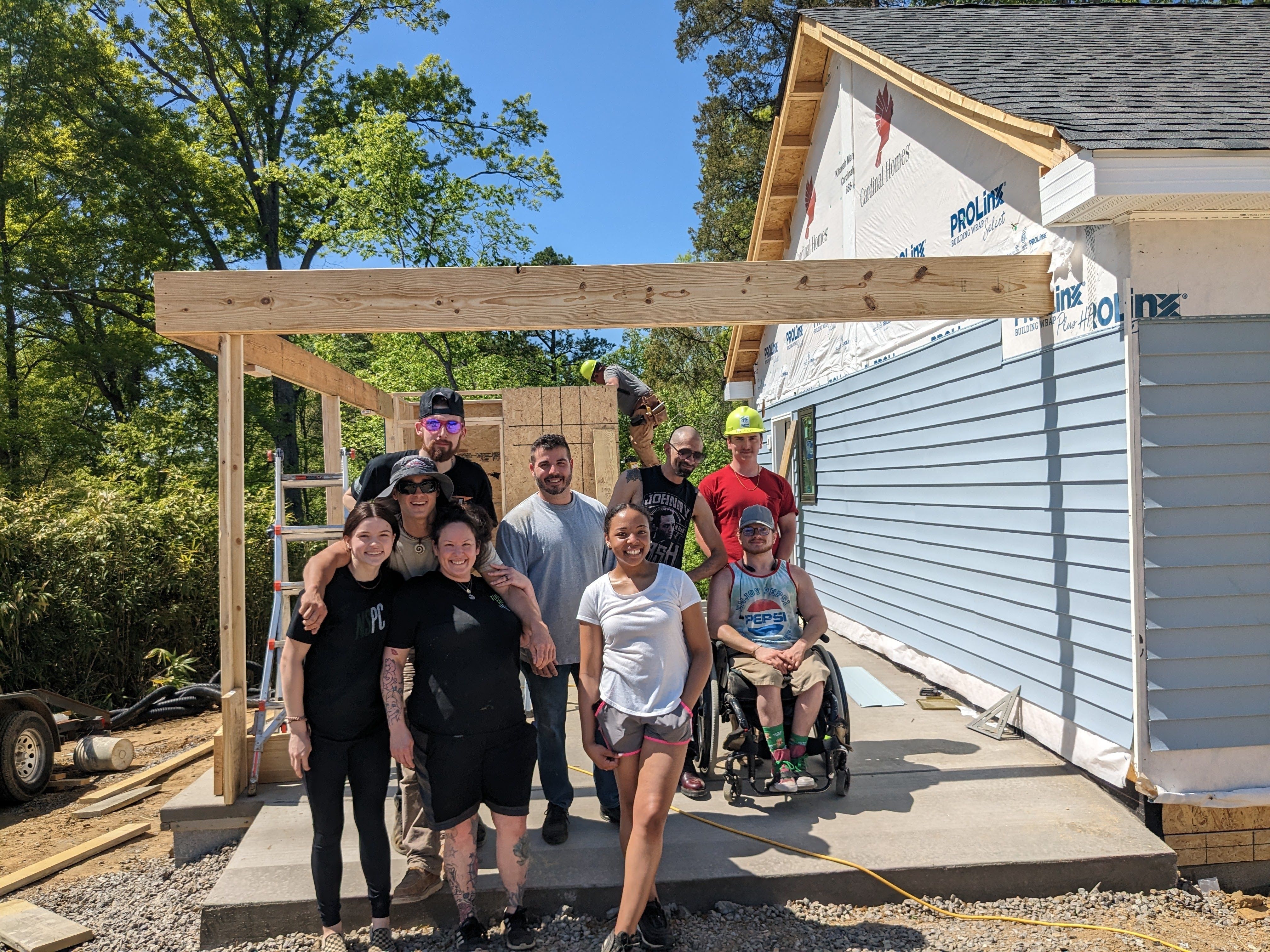 Volunteers putting on siding